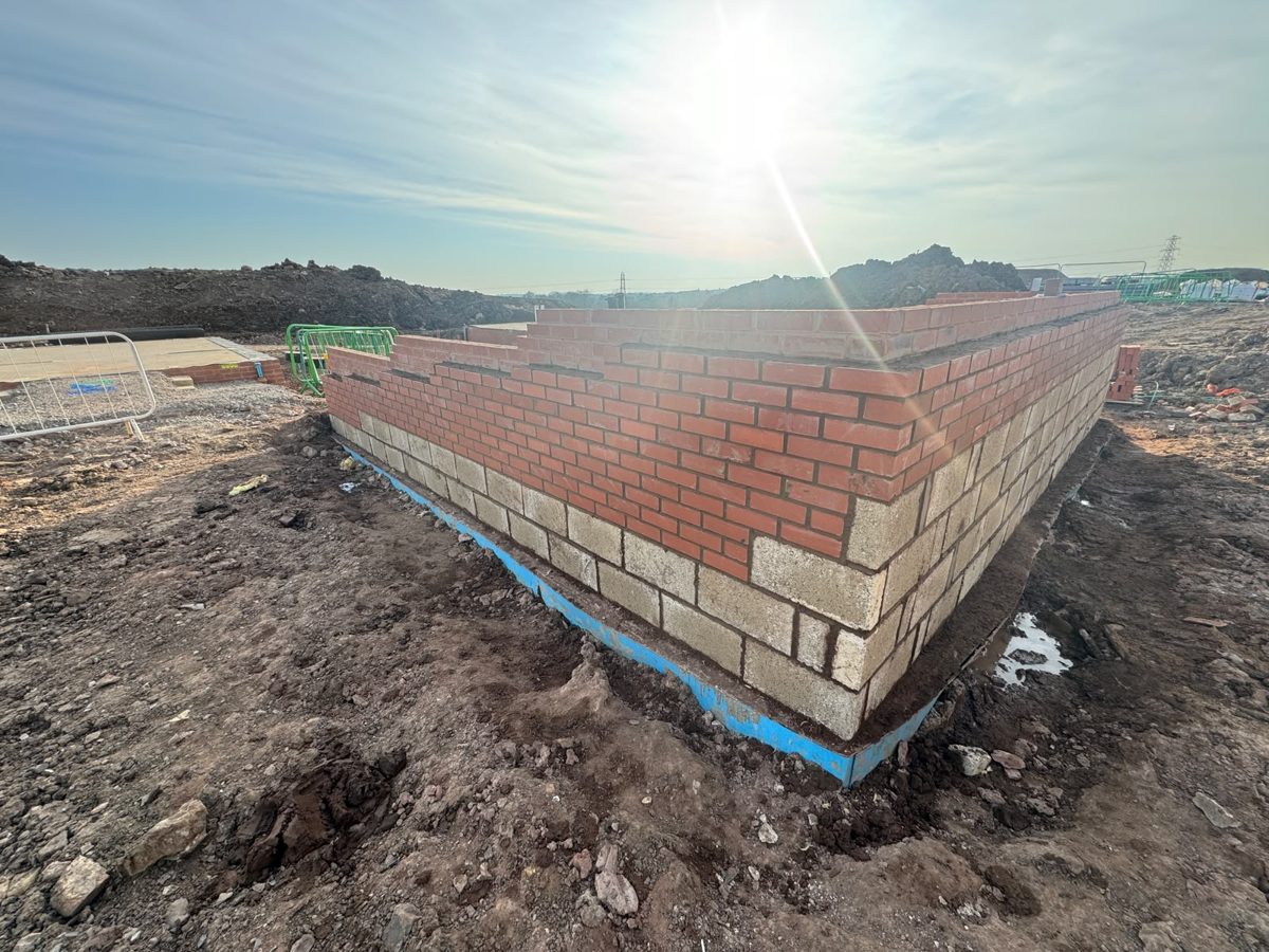 Brick and block substructure corner built up to damp course