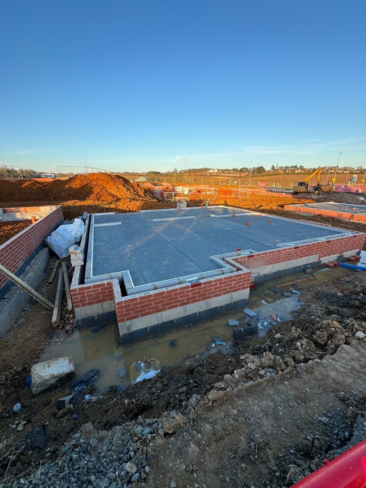 Concrete slab and oversite laid over substructure